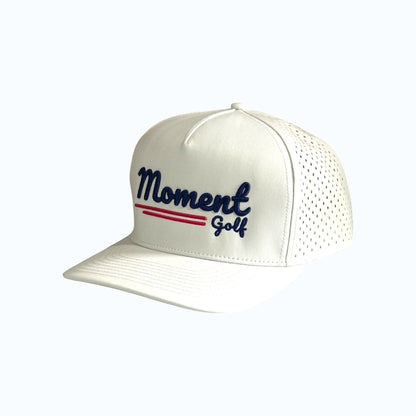 Moment Golf white 5-panel performance hat with laser-perforated side panels and embroidered script logo
