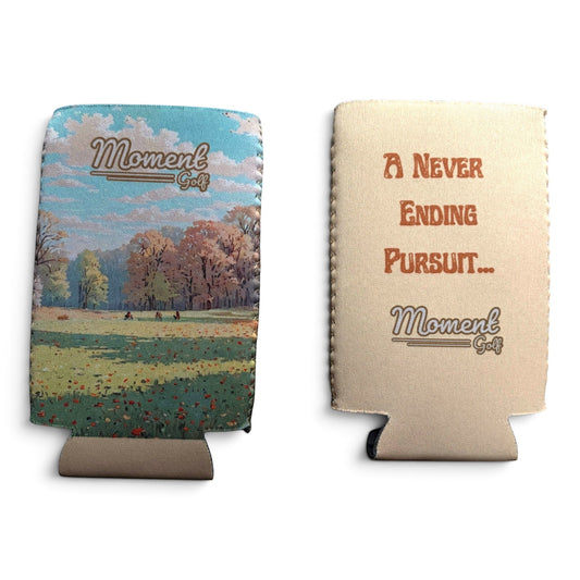 Moment Golf slim can koozie featuring an autumn landscape print on one side and brand text on the cream reverse side.
