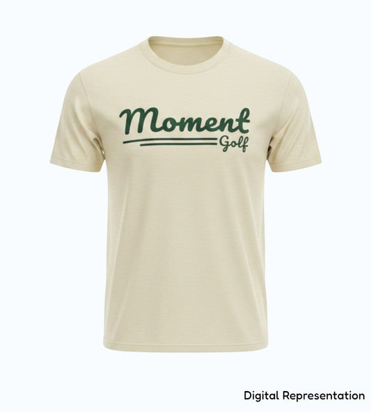 Moment Golf premium garment-dyed cotton t-shirt in beige with a forest green scripted logo on the chest.