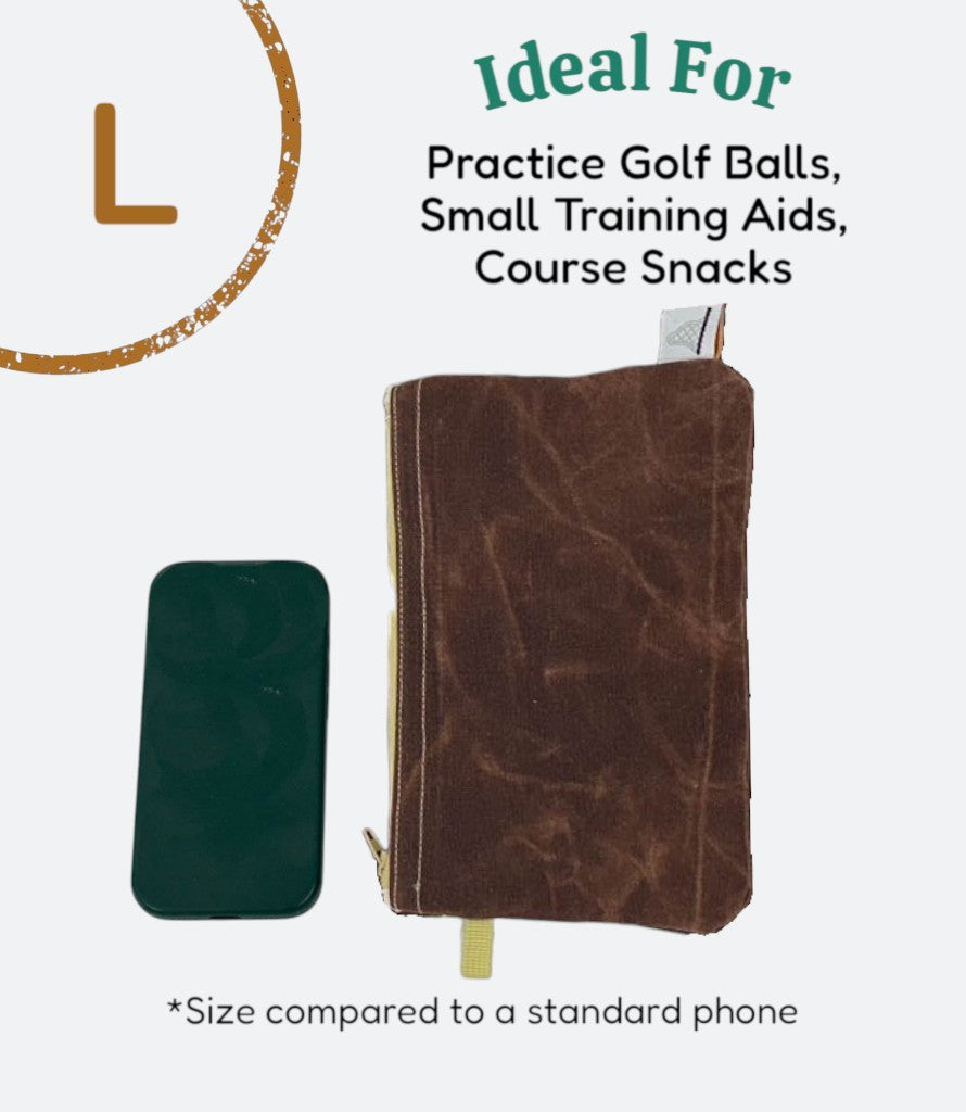 Moment Golf large blue waxed canvas utility bag with drawstring closure next to a smartphone for size reference.