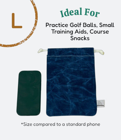 Moment Golf medium utility bag in blue waxed canvas with drawstring closure next to a smartphone for size reference