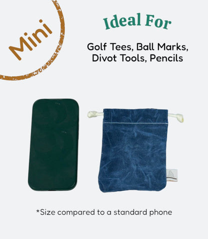 Moment Golf small blue waxed canvas utility bag with drawstring closure next to a smartphone for size reference